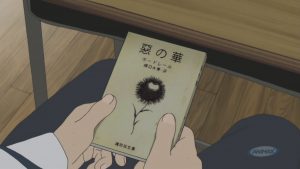 Figure 1: Kasuga holding his favourite book, Charles Baudelaire’s Flowers of Evil